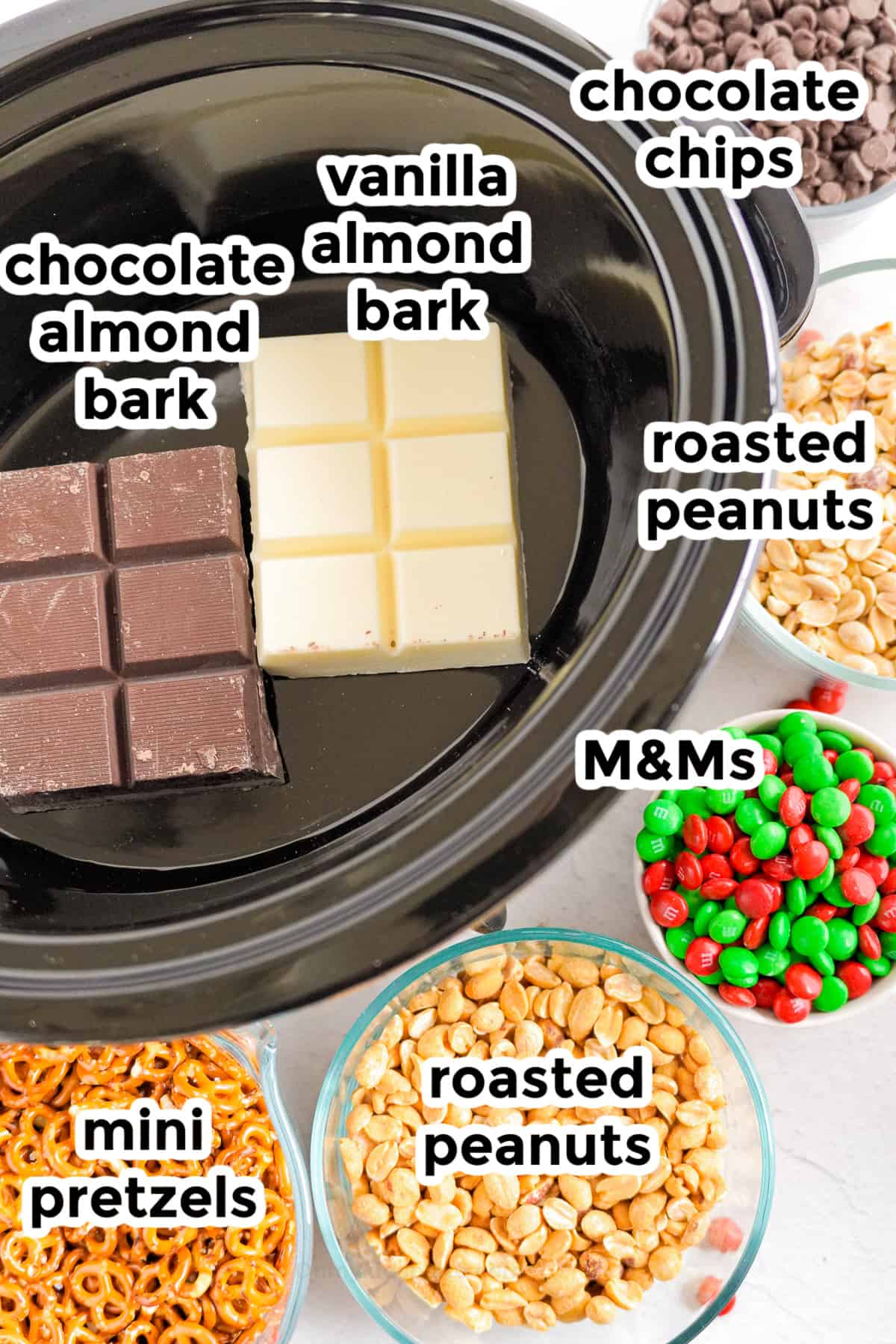 Ingredients for crockpot candy in bowls next to a crockpot filled with vanilla and chocolate almond bard with title text labels.