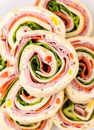 Close up overhead on a platter of Italian pinwheels in slices.