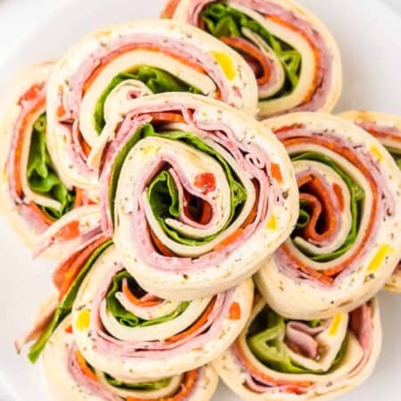Close up overhead on a platter of Italian pinwheels in slices.
