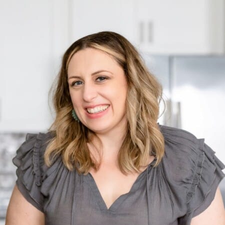 Kristy Richardson, owner of On My Kids Plate, standing in kitchen smiling.
