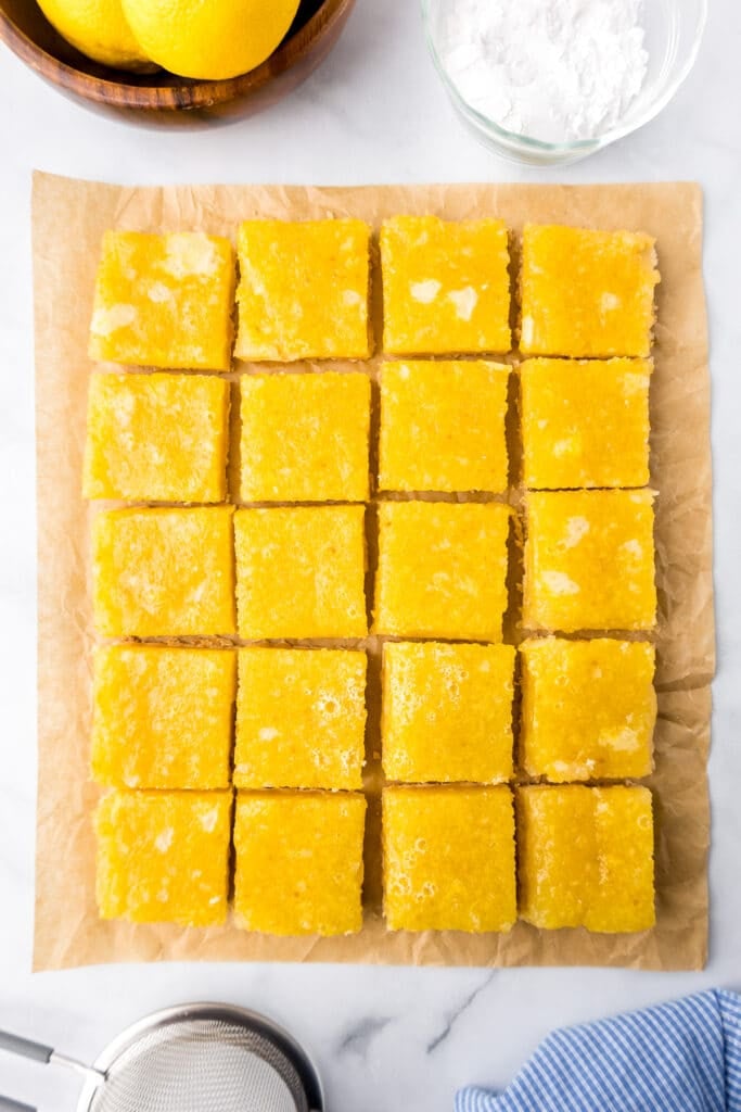Lemon bars sliced and trimmed from overhead on a counter.