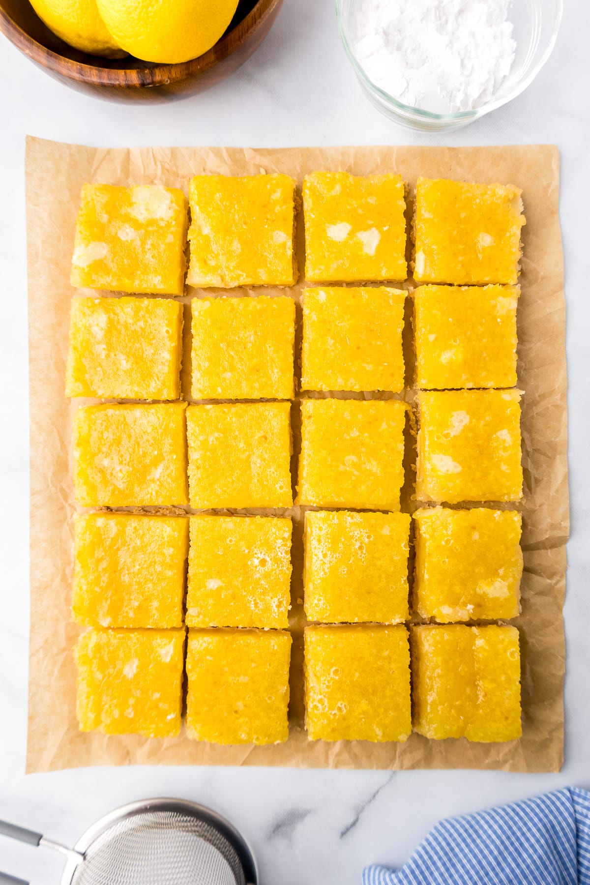 Lemon bars sliced and trimmed from overhead on a counter.
