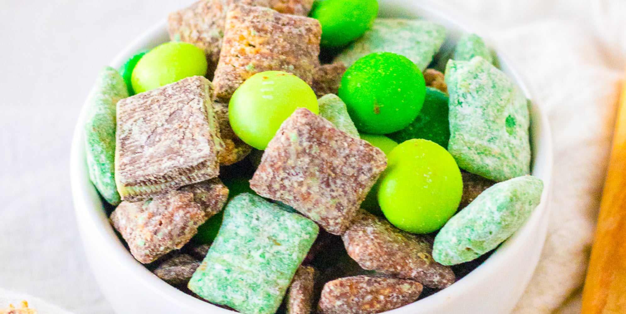 Wide vide of a bowl of mint muddy buddies from the side.