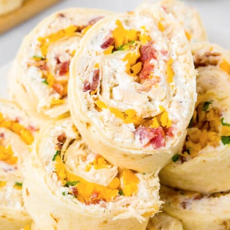 Close up focus on a chicken bacon ranch pinwheel at the top of a stack.