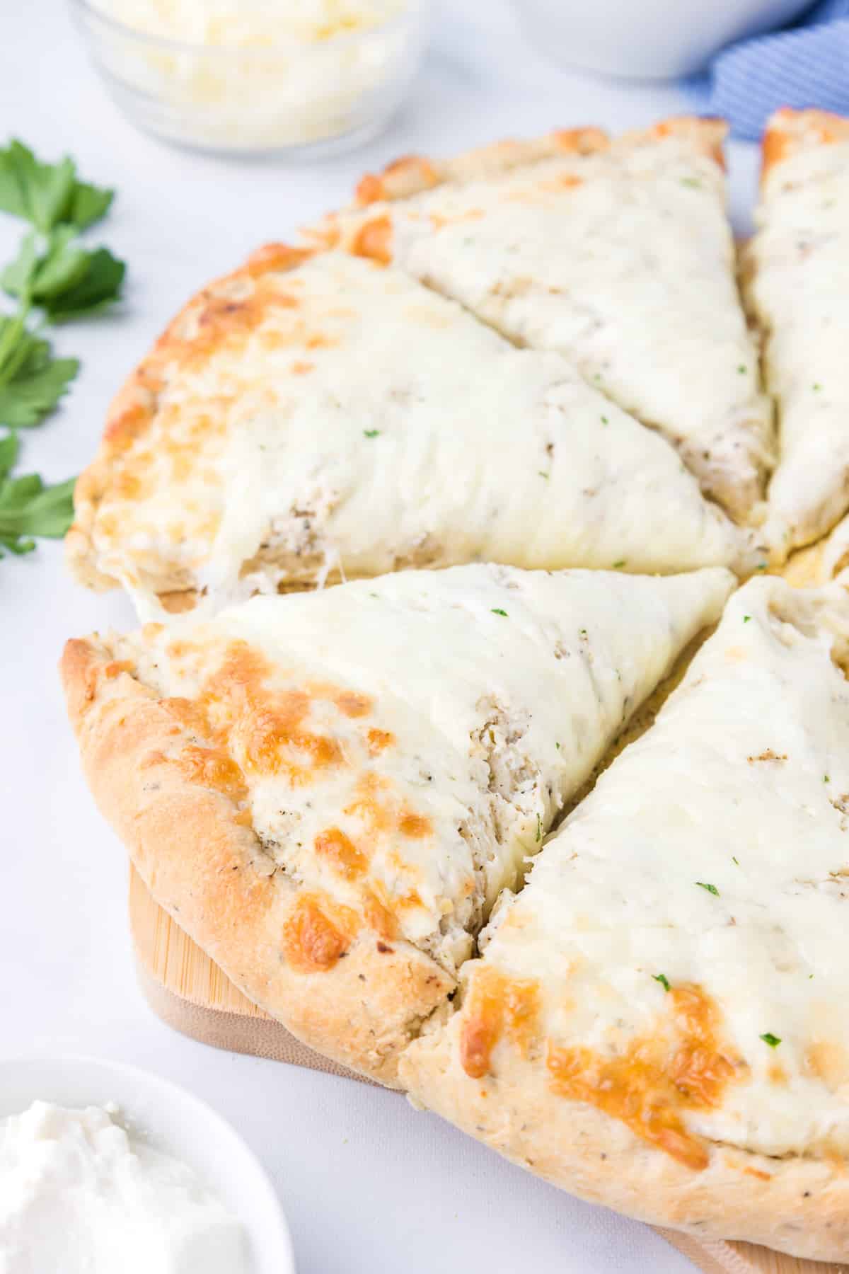 Slices of white pizza ready to serve close up.