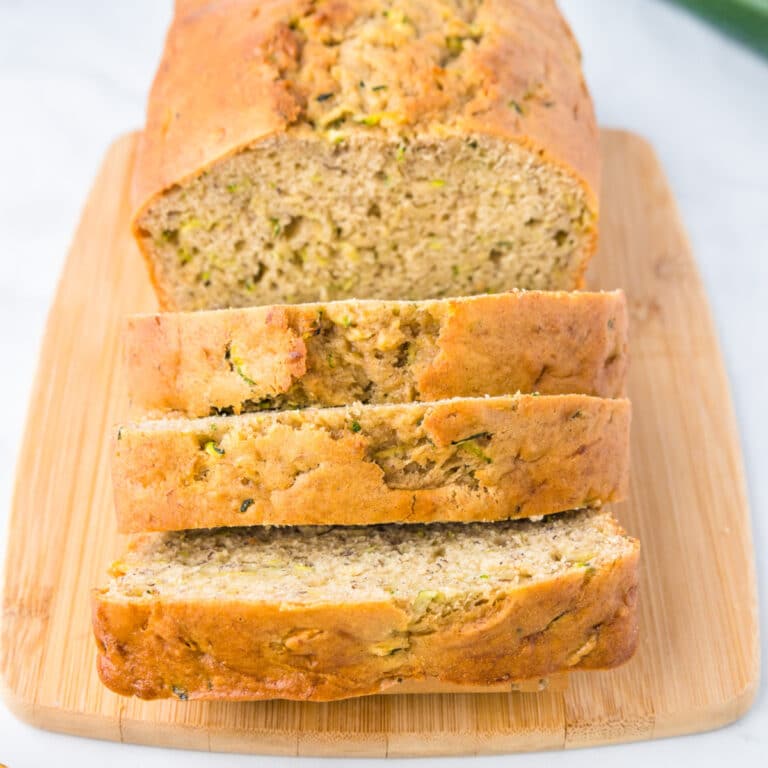 Sliced zucchini banana bread from the end of the loaf on a cutting board up close.