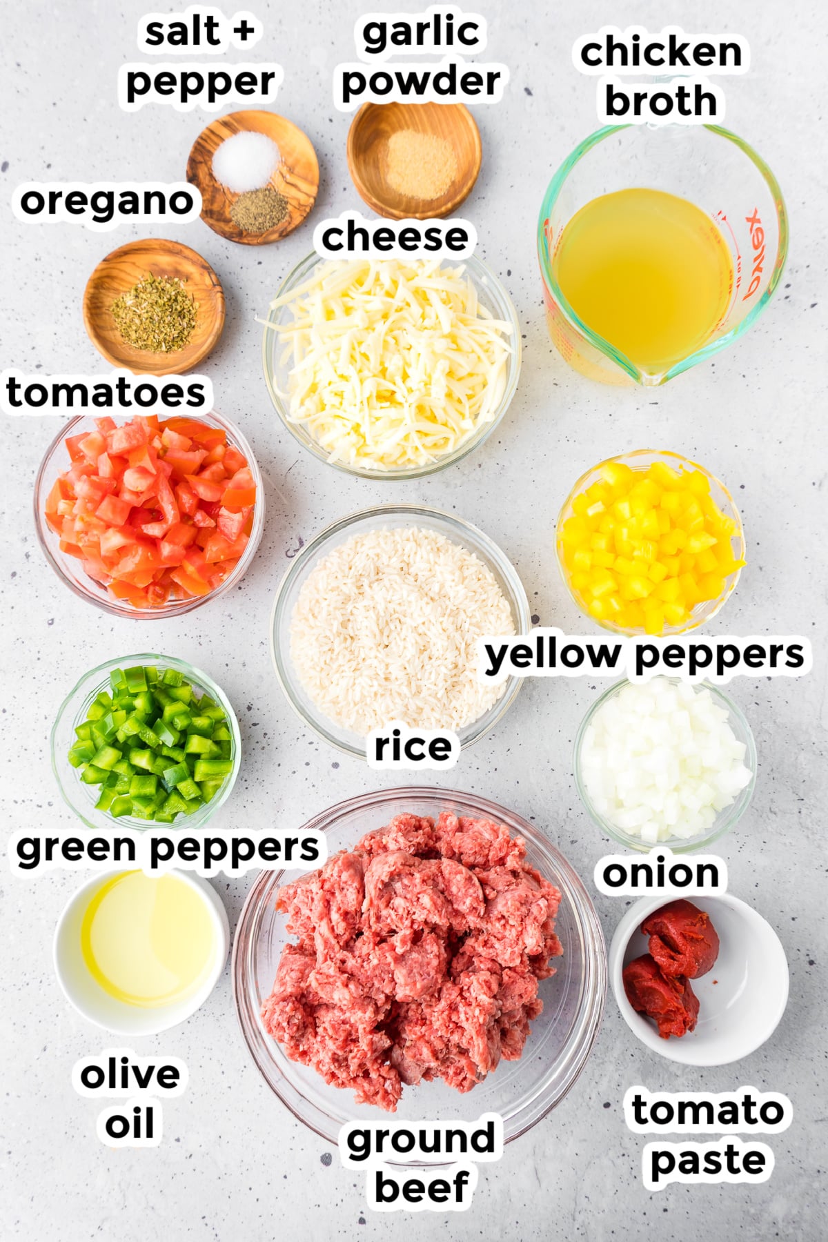 Ingredients for unstuffed pepper skillet in bowls from overhead on a counter with tesxt labels.