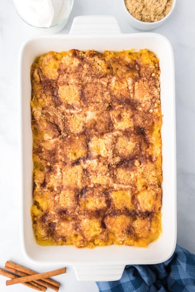 Baked peach dump cake in a pan from overhead bubbling and gooey.
