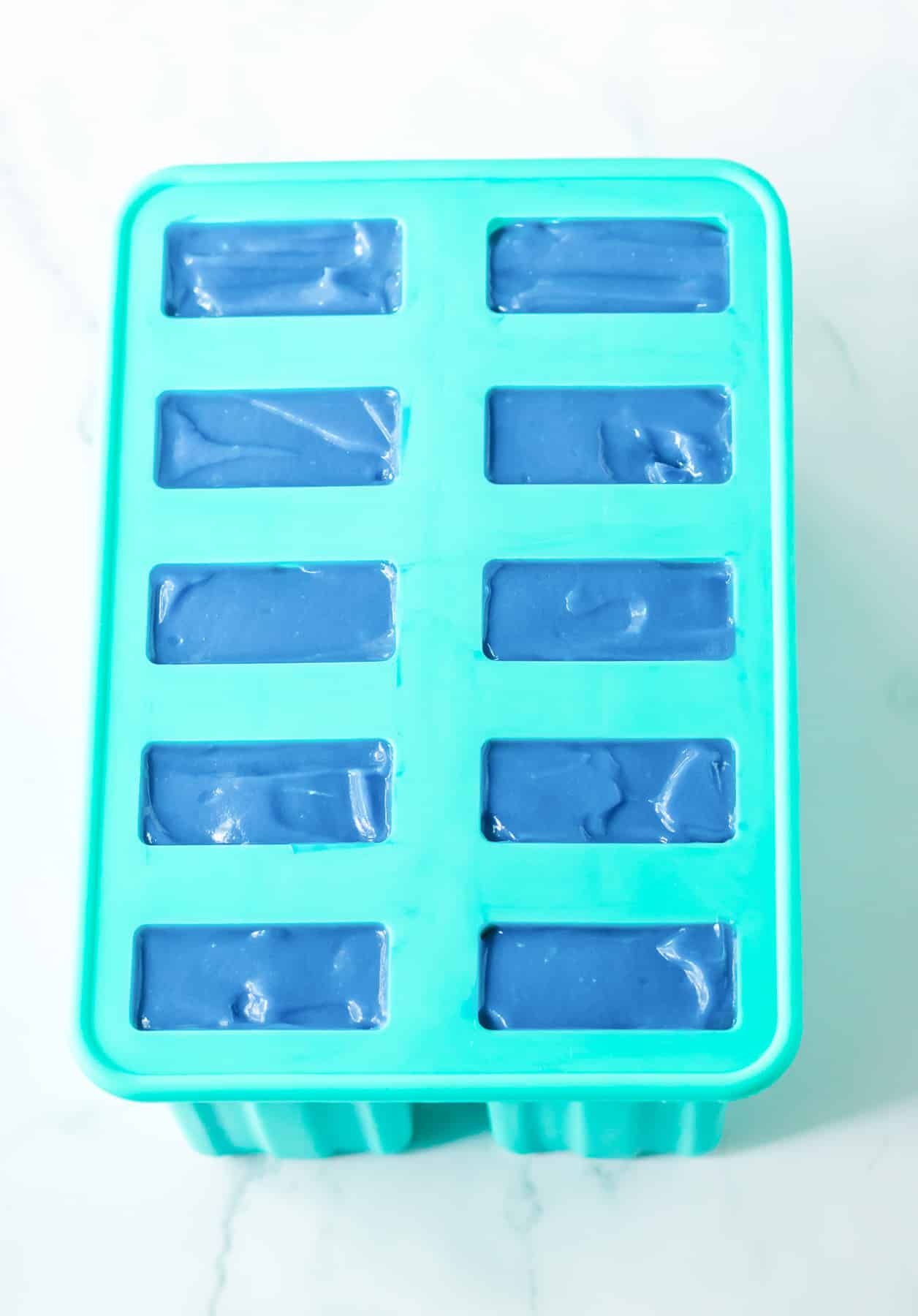 Silicone popsicle models from overhead full of blue pudding.