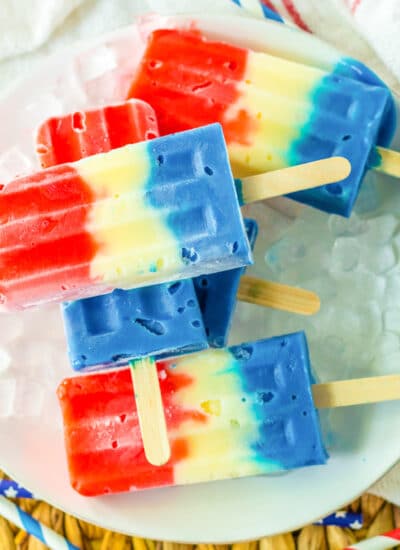 Red white and blue popsicles piled on a plate from overhead.