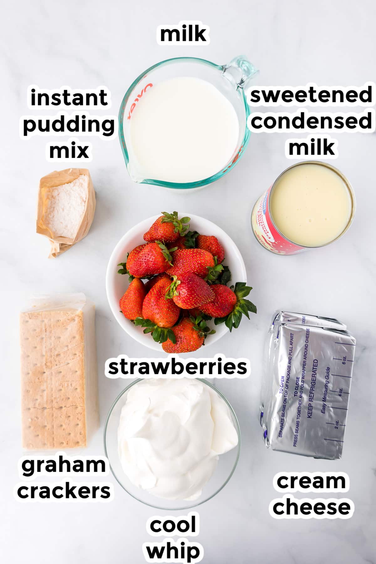 Ingredients for strawberry cream cheese ice box cake in bowls from overhead on a counter with text labels.
