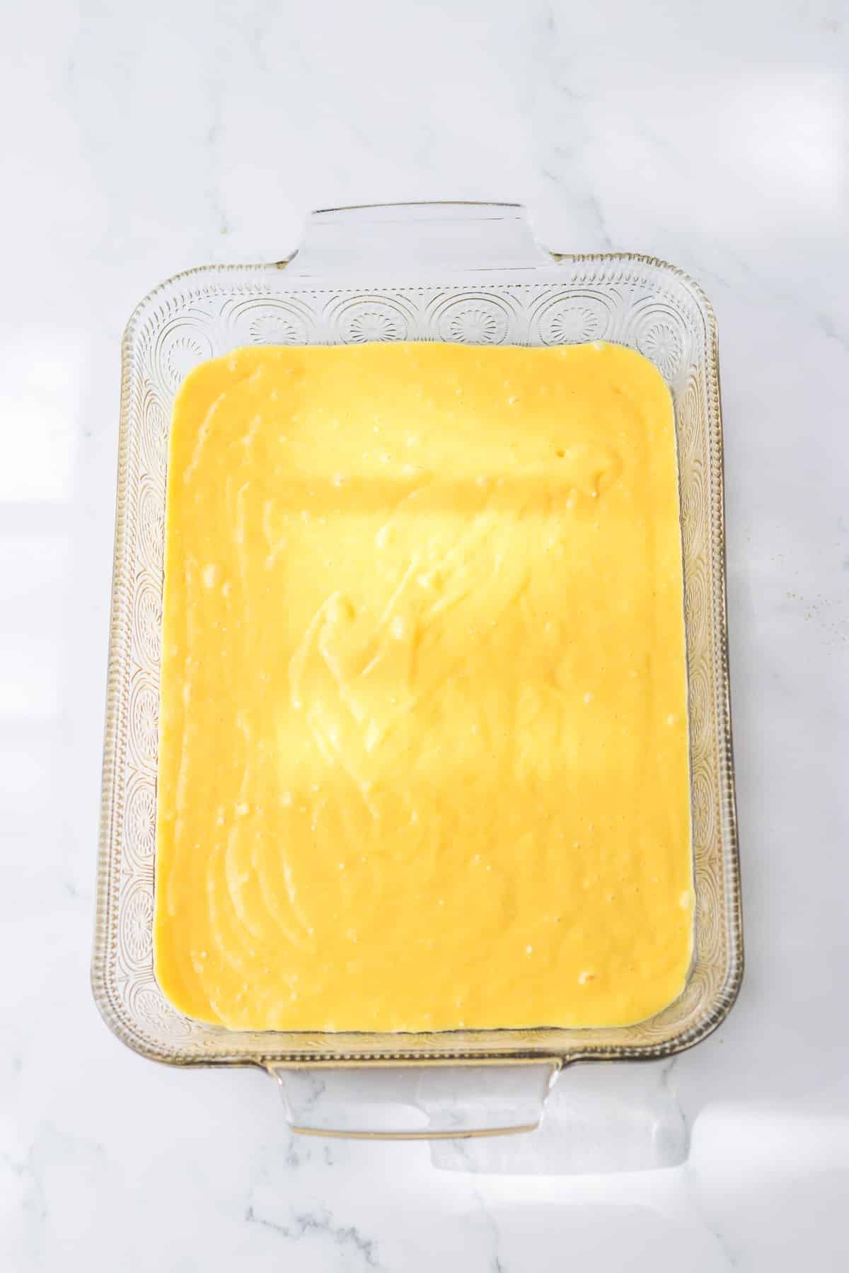 Cake batter in a large rectangle pan from overhead.
