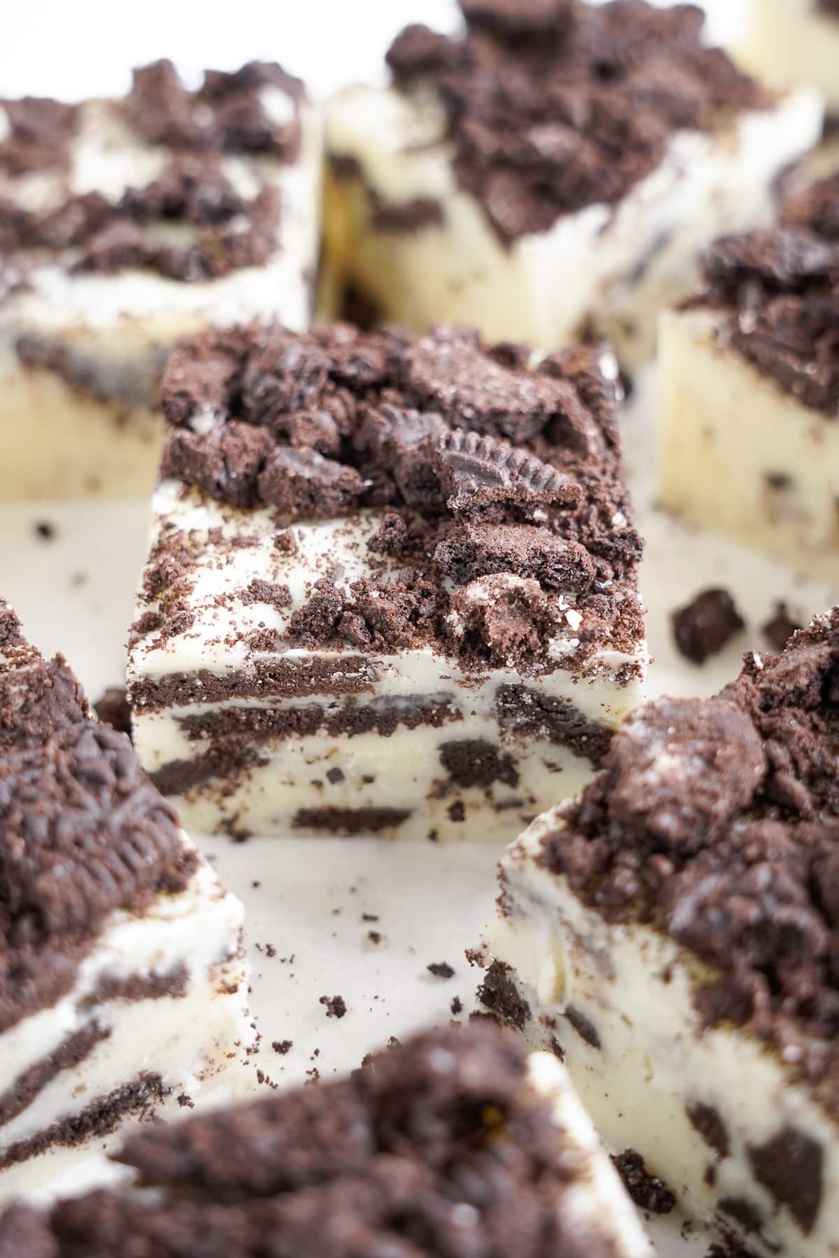 Slices of cookies and cream fudge on the counter form the side with a close up focus on the center piece.