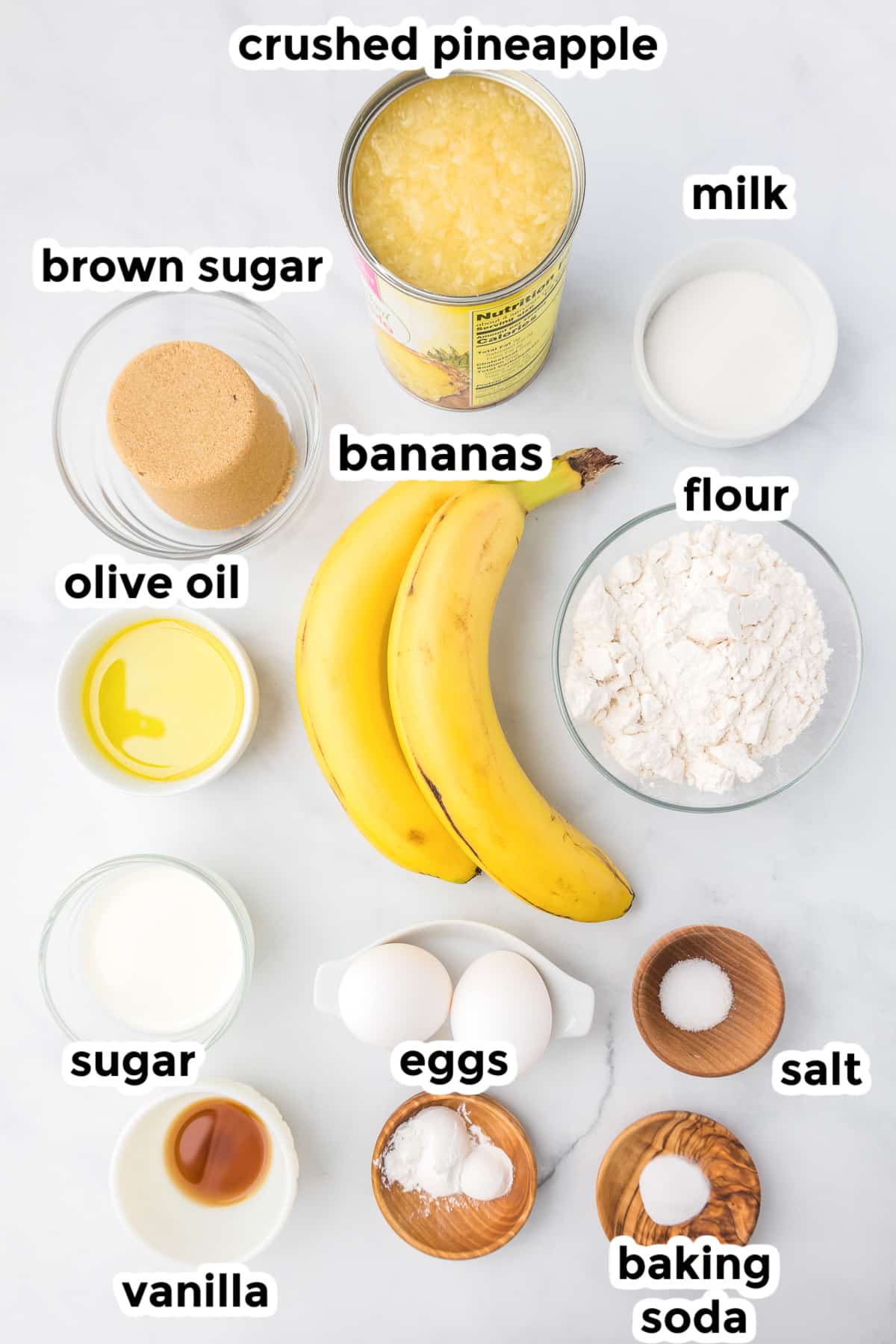 Ingredients for banana pineapple bread from overhead on a counter with title text labels.