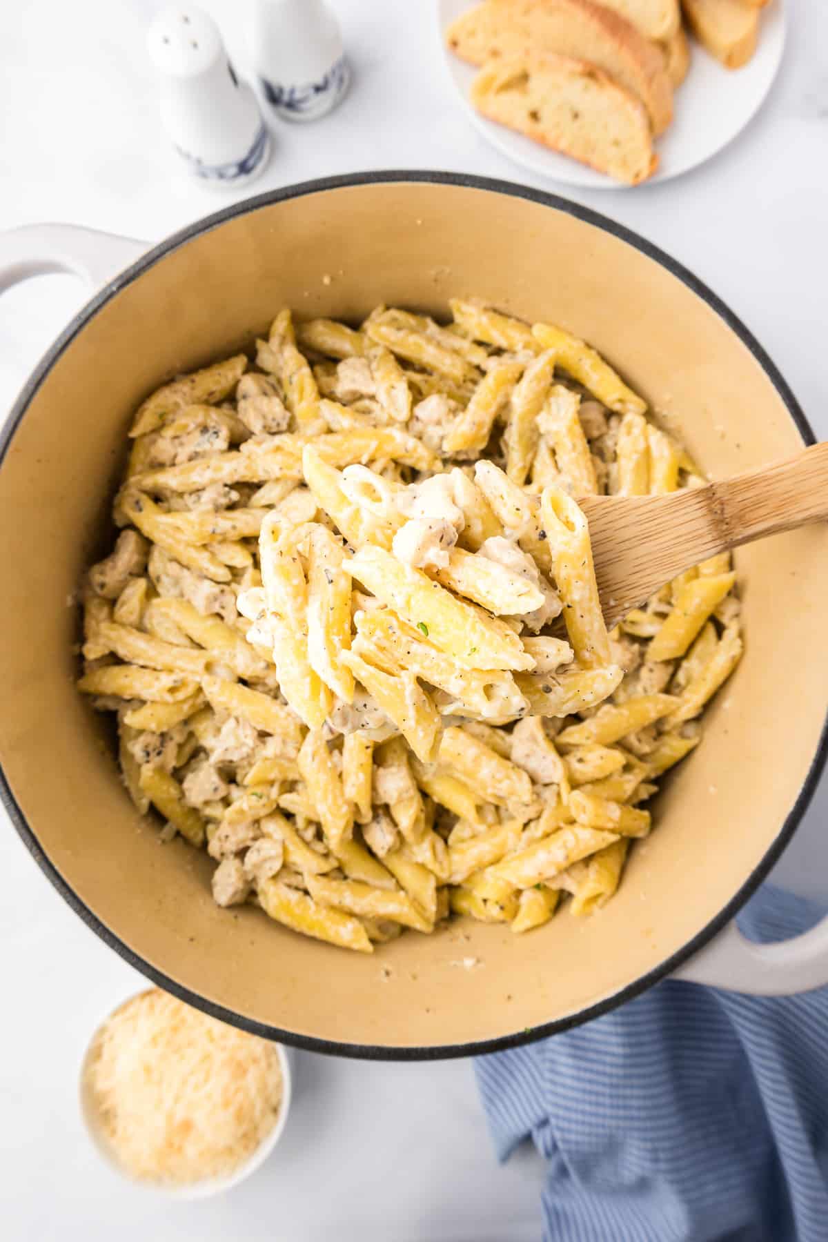 Chicken penne alfredo finished cooking in a pot from above.