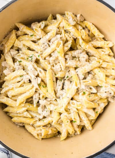 Square close up overhead view of chicken alfredo pasta in a pot.