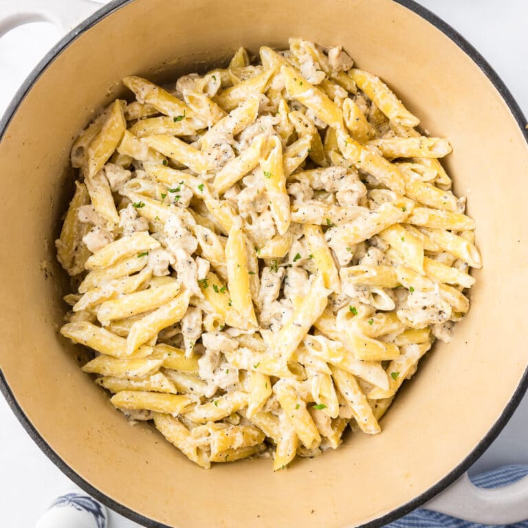 Square close up overhead view of chicken alfredo pasta in a pot.