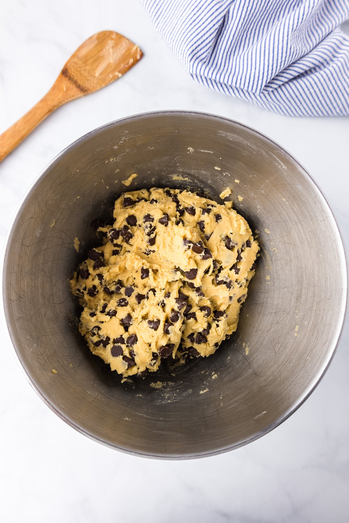 Chocolate chip cookie dough in a mixing bowl from overhead.