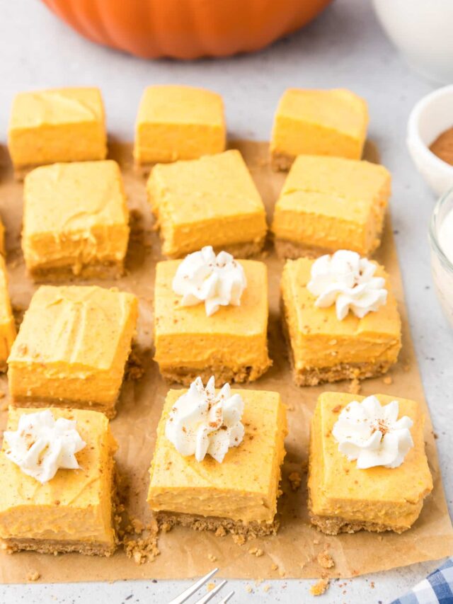 Pumpkin cheesecake squares on a baking sheet.