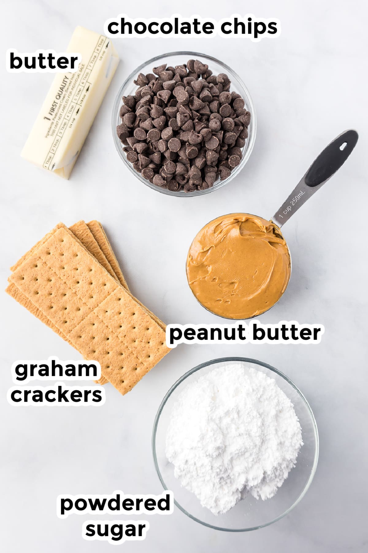 Ingredients for peanut butter bars in bowls on a counter from overhead with text labels.