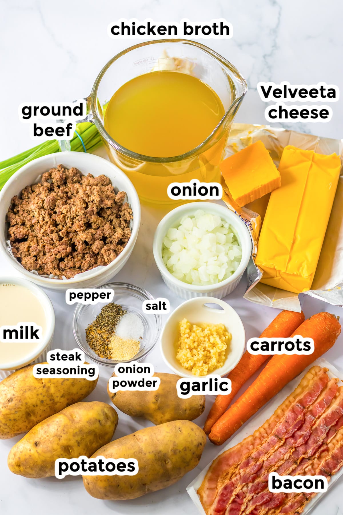 Ingredients in bowls from overhead for bacon cheeseburger soup.