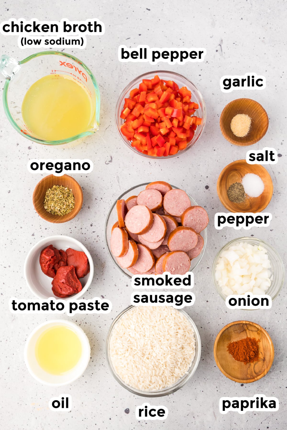 Ingredients for smoked sausage and rice in bowls on a counter from overhead with title text overlays.