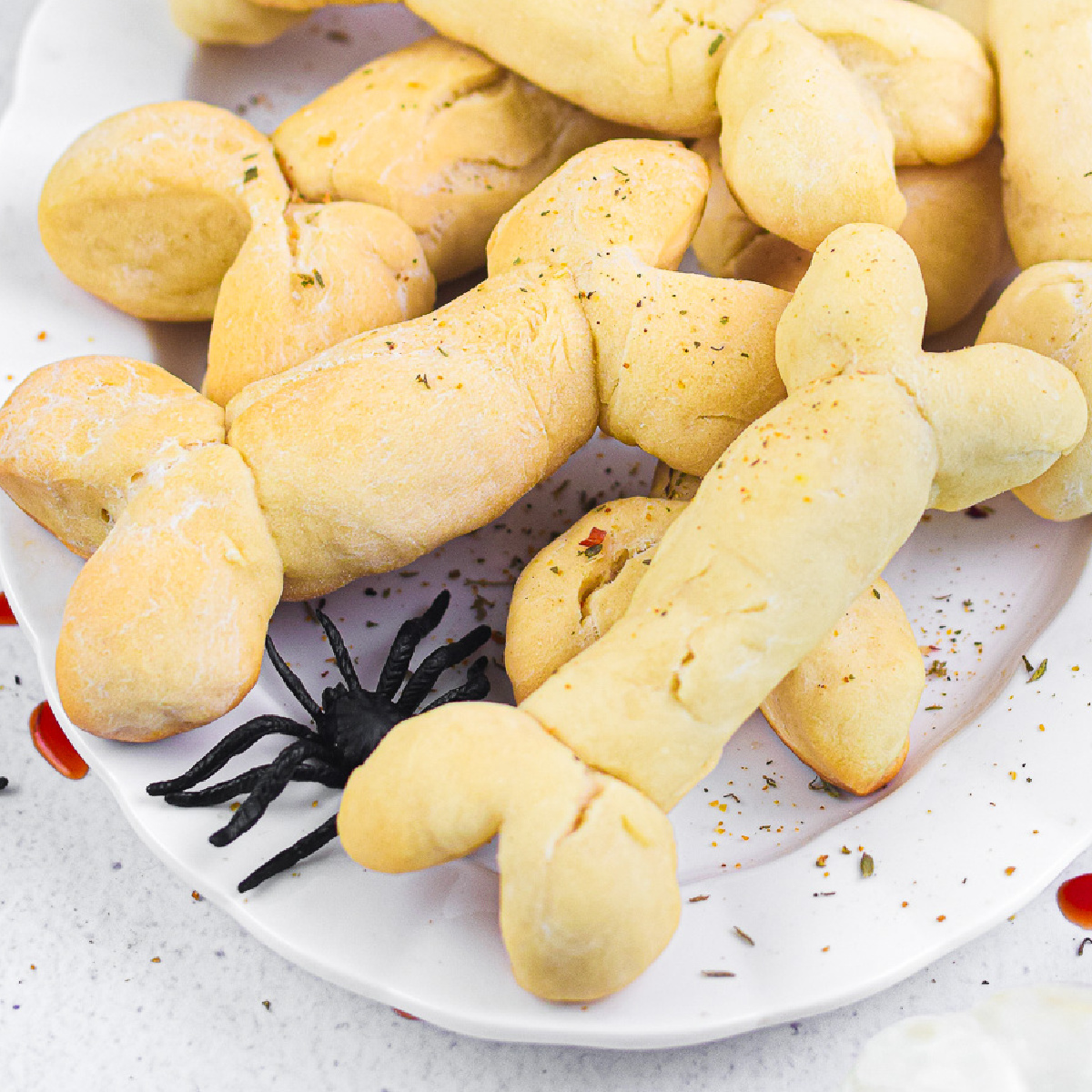 A plate of Halloween-themed dog bone shaped cookies on a table.