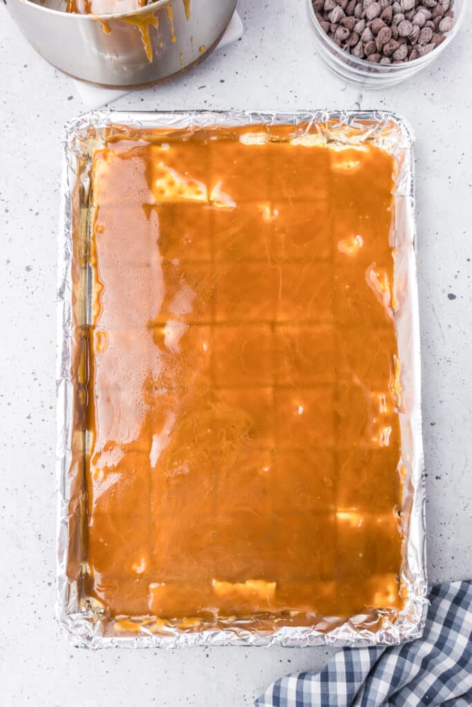 A baking sheer with a layer of liquid toffee over saltines.