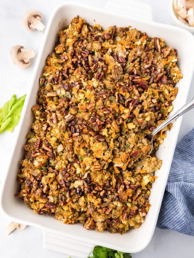 A casserole dish filled with stuffing and mushrooms.