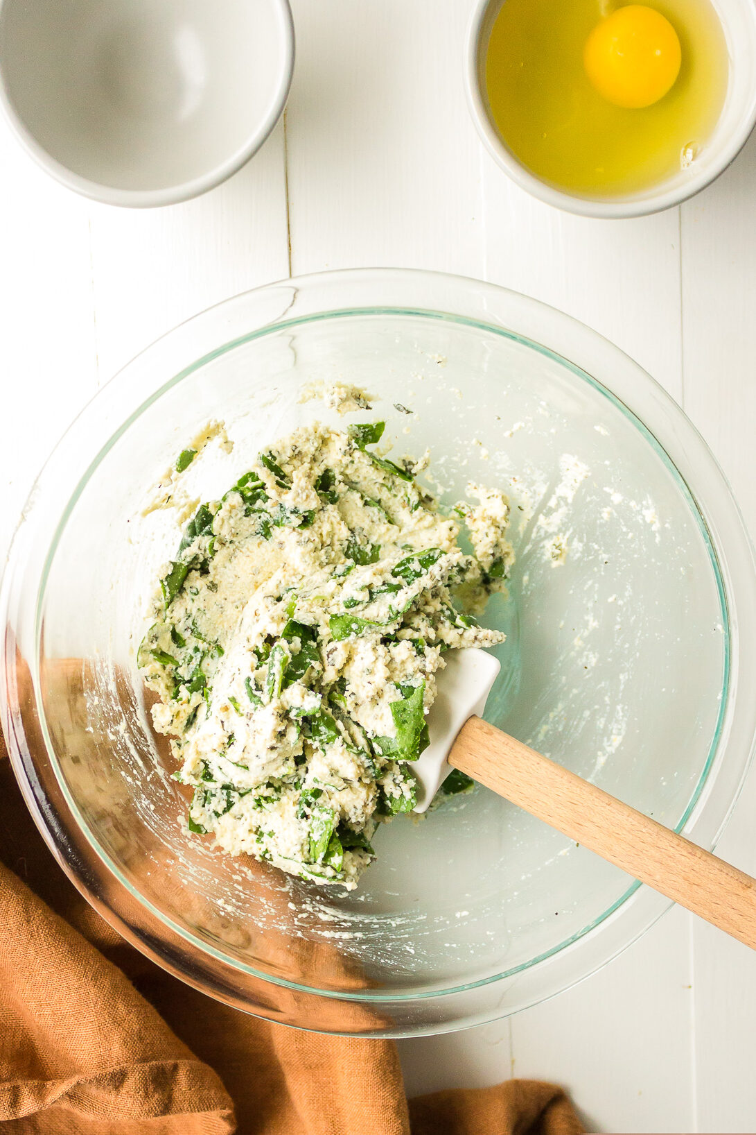 Spinach and ricotta cheese after mixing in a large mixing bowl.