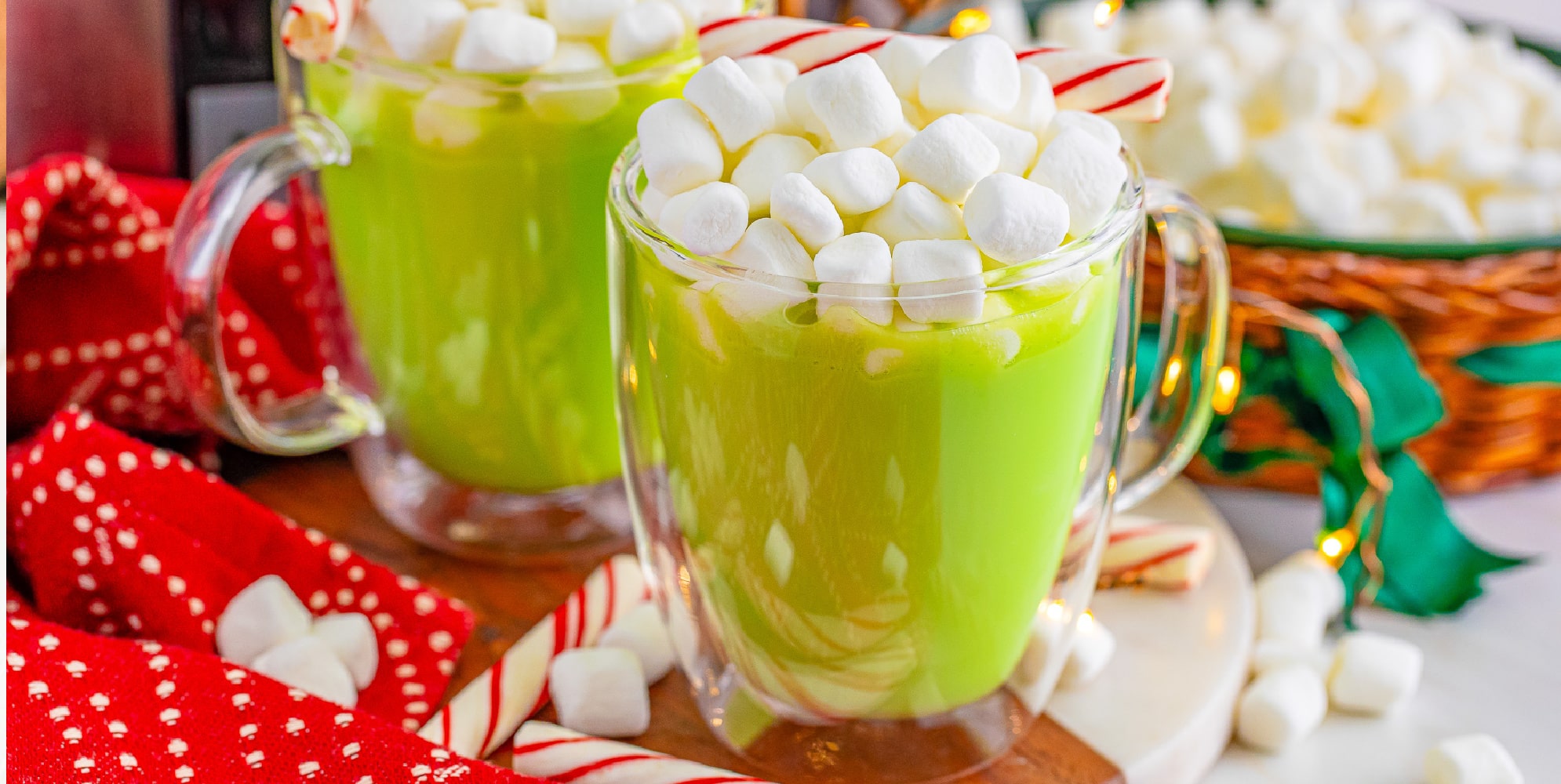 Green hot chocolate with marshmallows and candy canes.