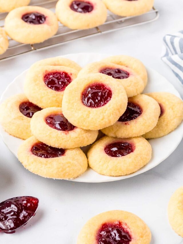 A plate of cookies with jam on it.