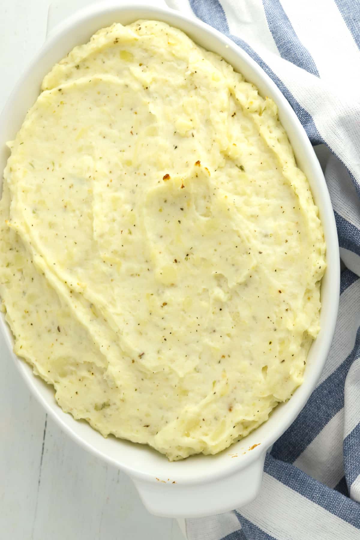 Mashed potatoes in a white casserole dish.