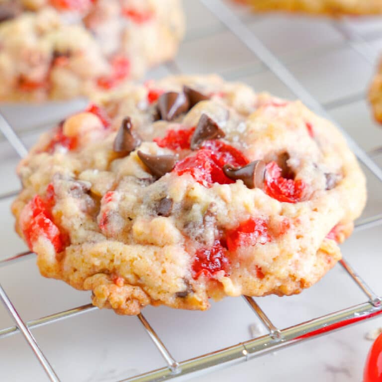 Maraschino cherry chocolate chip cookie close up on a cooling rack.