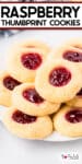 Close up tall image of raspberry thumbprint cookies piles on a plate.