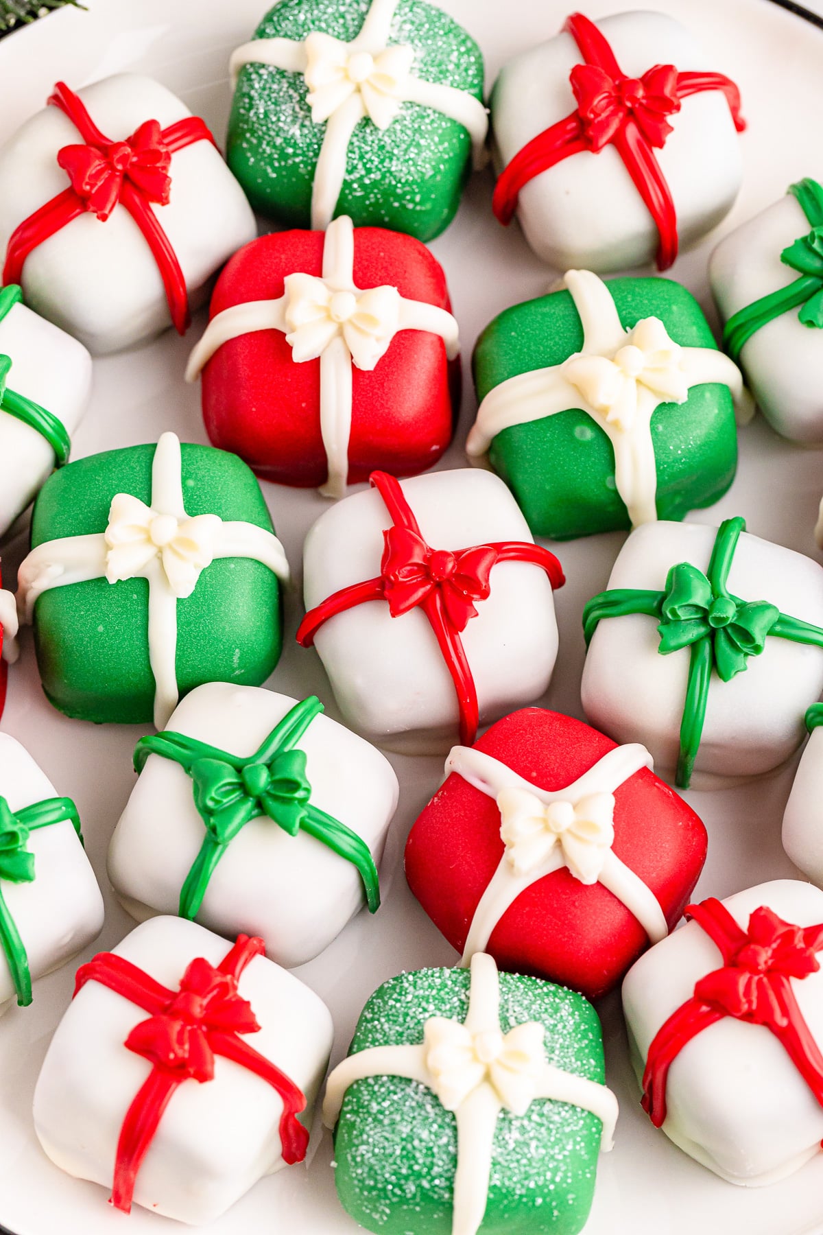 Christmas Oreo truffles shaped like presents close up with red, green and white bows.