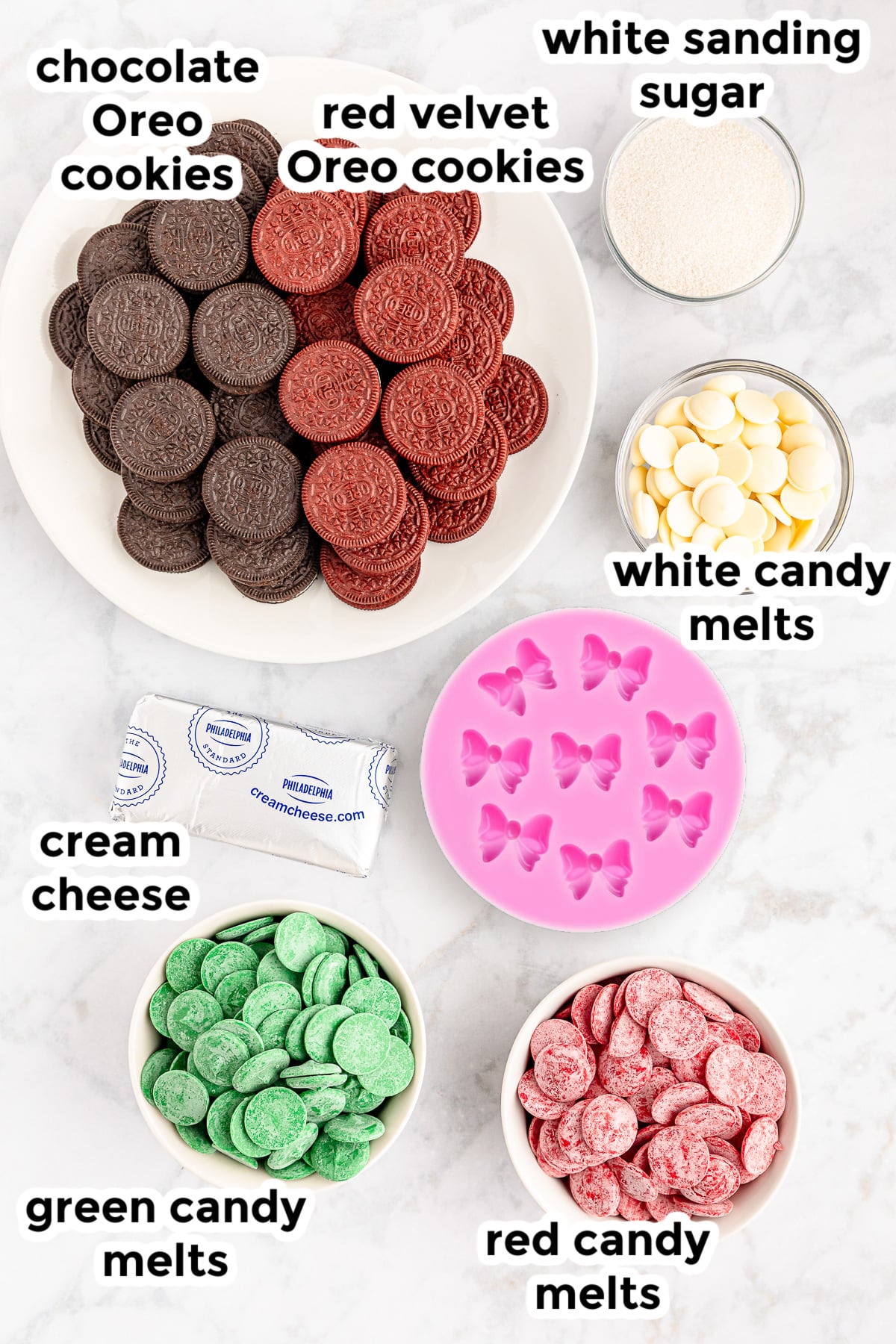 Ingredients for christmas present oreo balls on a counter in bowls with text labels.