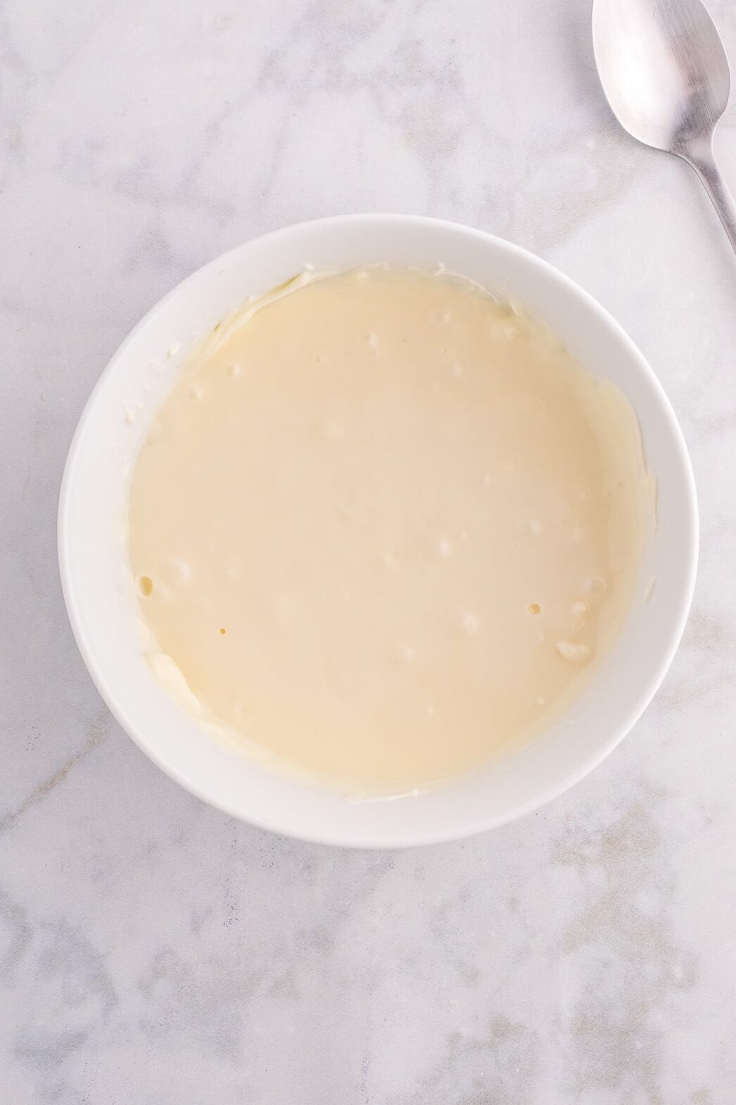 Melted white chocolate in a bowl.