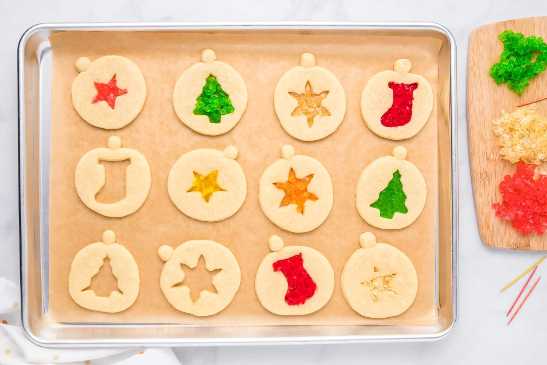 A tray of cookies with gummy ornaments on it.