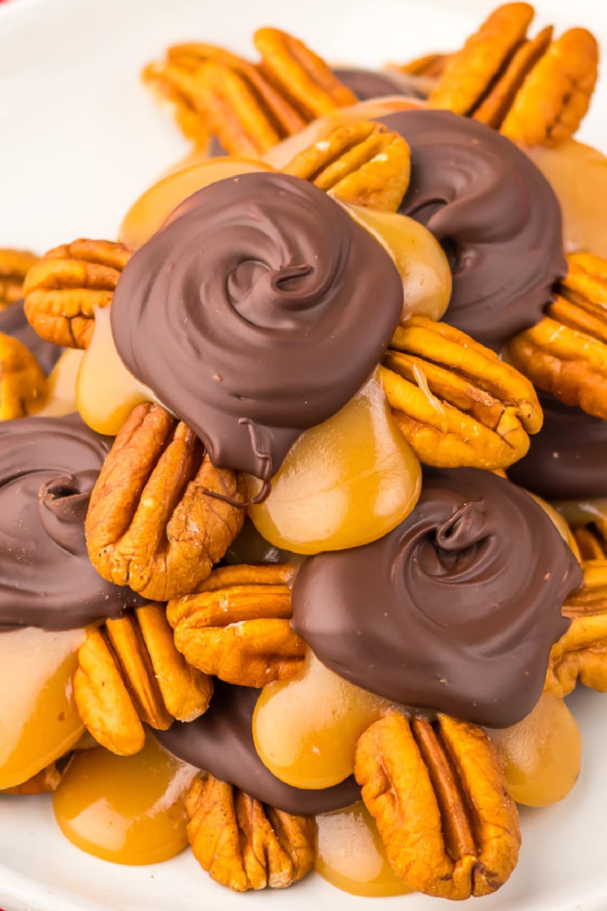 A plate of chocolate caramel turtle candy piled high