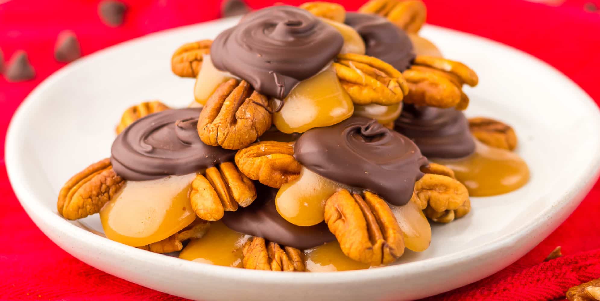 A plate of homemade turtle candies stacked on a plate from the side.