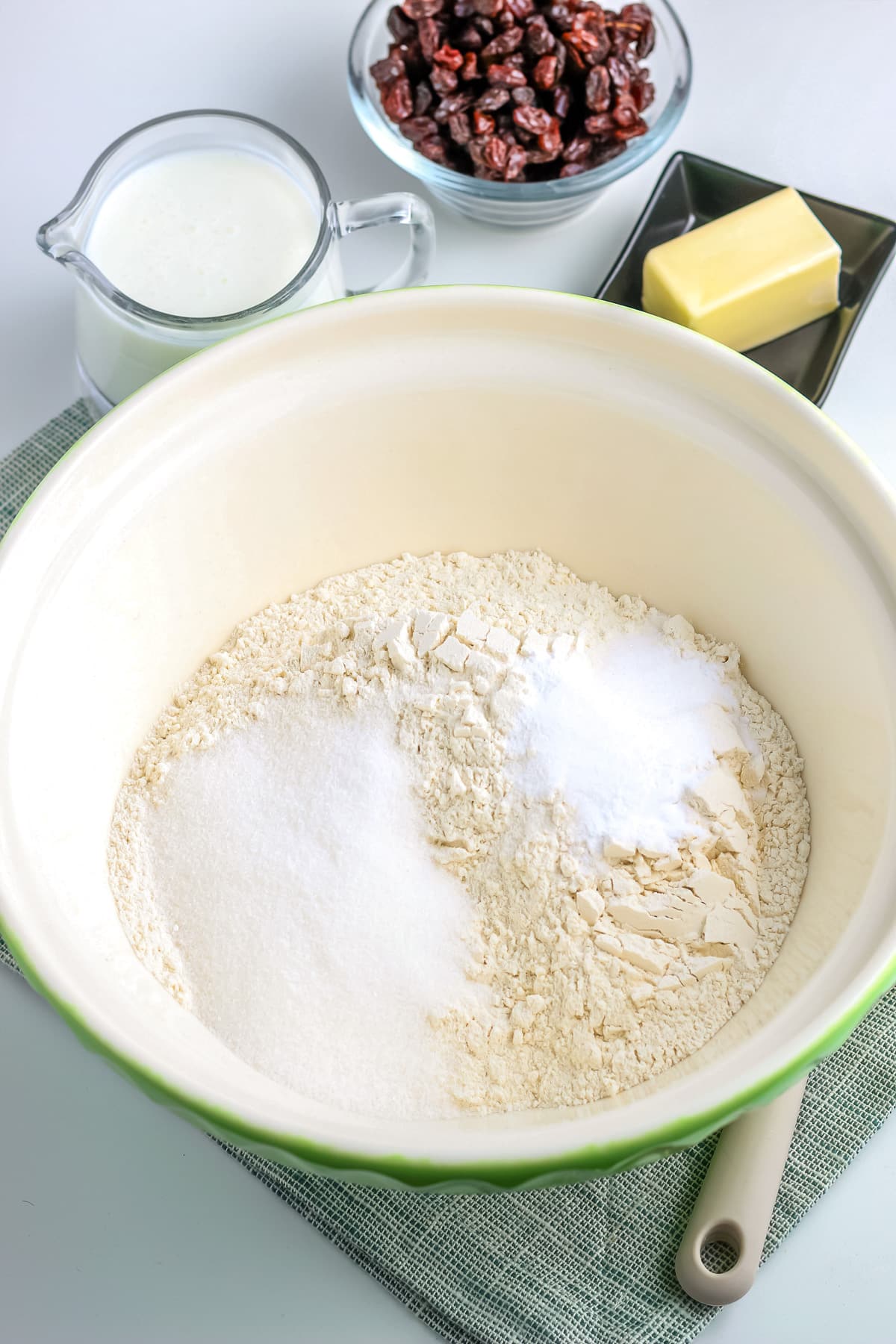 Mixing together flour, salt, sugar and other dry ingredients for Irish soda bread in a large mixing bowl.