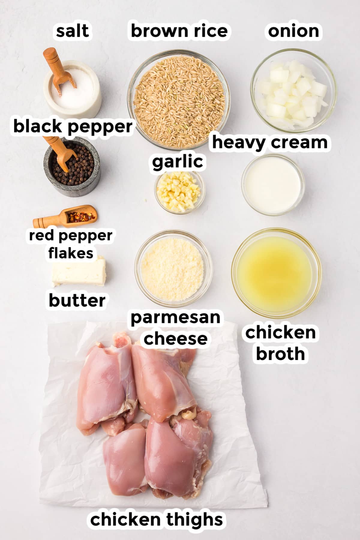 Ingredients for creamy chicken and rice in bowls with text labels.