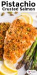 A plate of pistachio crusted salmon on top of asparagus with lemon wedges and title on top of the image.