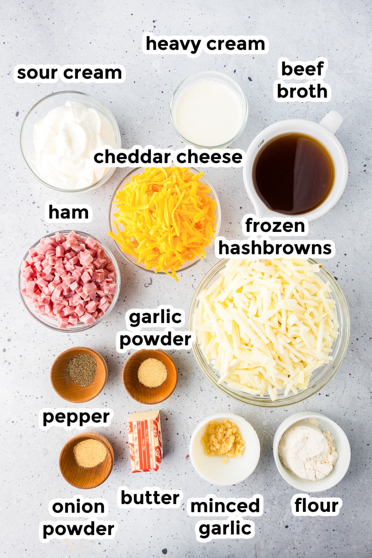 Ingredients for a potato soup recipe neatly labeled and arranged on a kitchen counter.