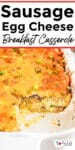 Close-up view of a sausage, egg, and cheese breakfast casserole in a baking dish with title text overlay on top.