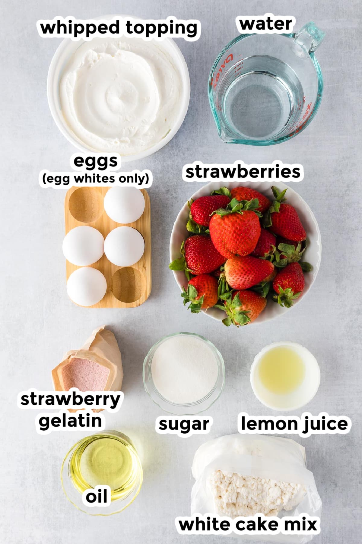 Ingredients for strawberry Jello cake in bowls on a counter with text labels over top.