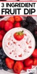 Tall view of cream cheese fruit dip with a strawberry in the dip surrounded by a platter for berries and title text at the top of the image.