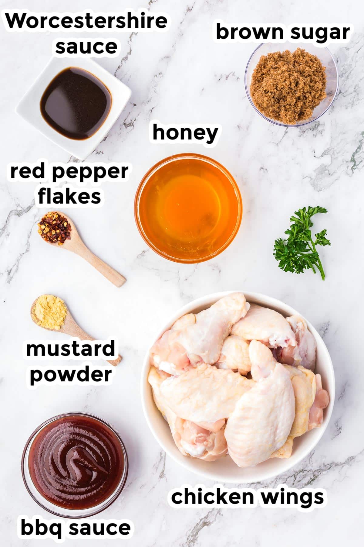 Ingredients for crock pot bbq chicken wings in bowls from overhead on a counter with text labels.