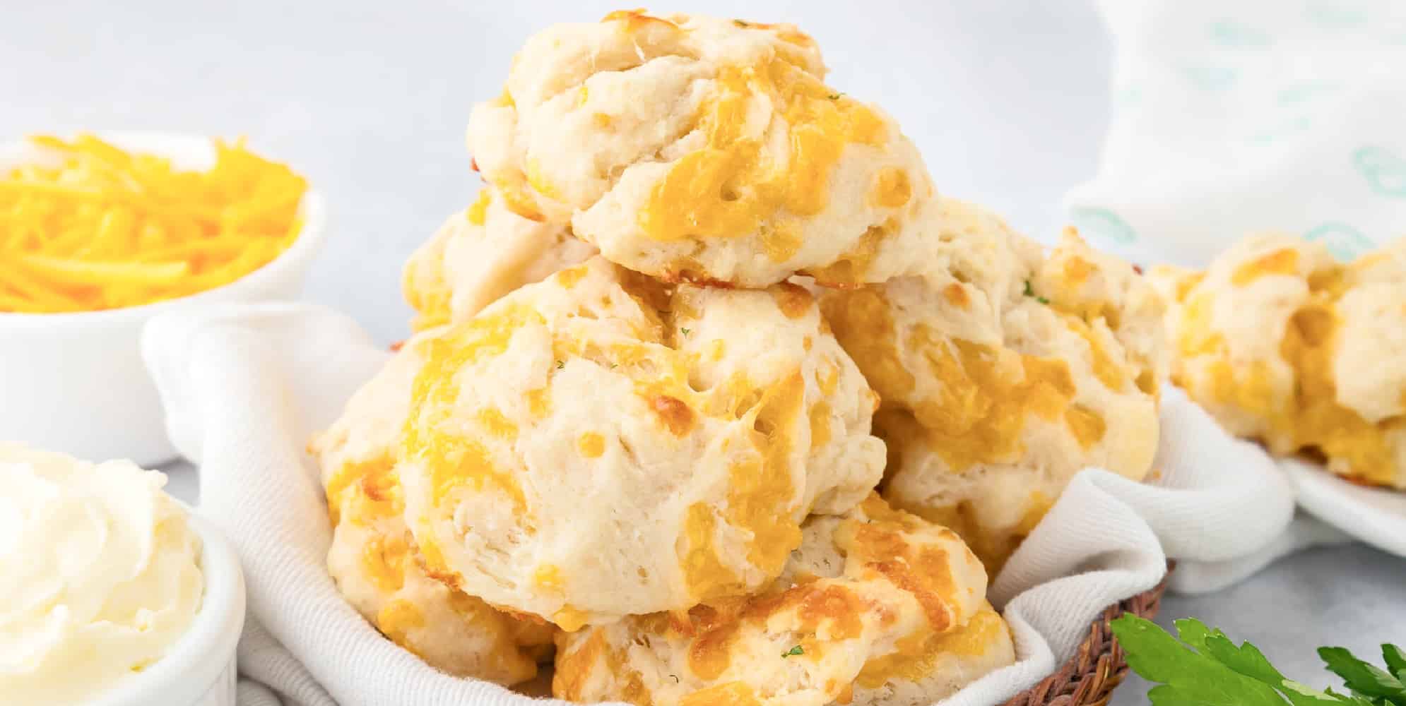 A basket of garlic cheese biscuits piled high from the side.